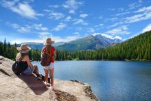 two women looking at an alpine lake in the Rocky Mountains